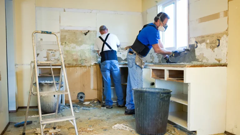 Workers removing interior finishes during a reconstruction project