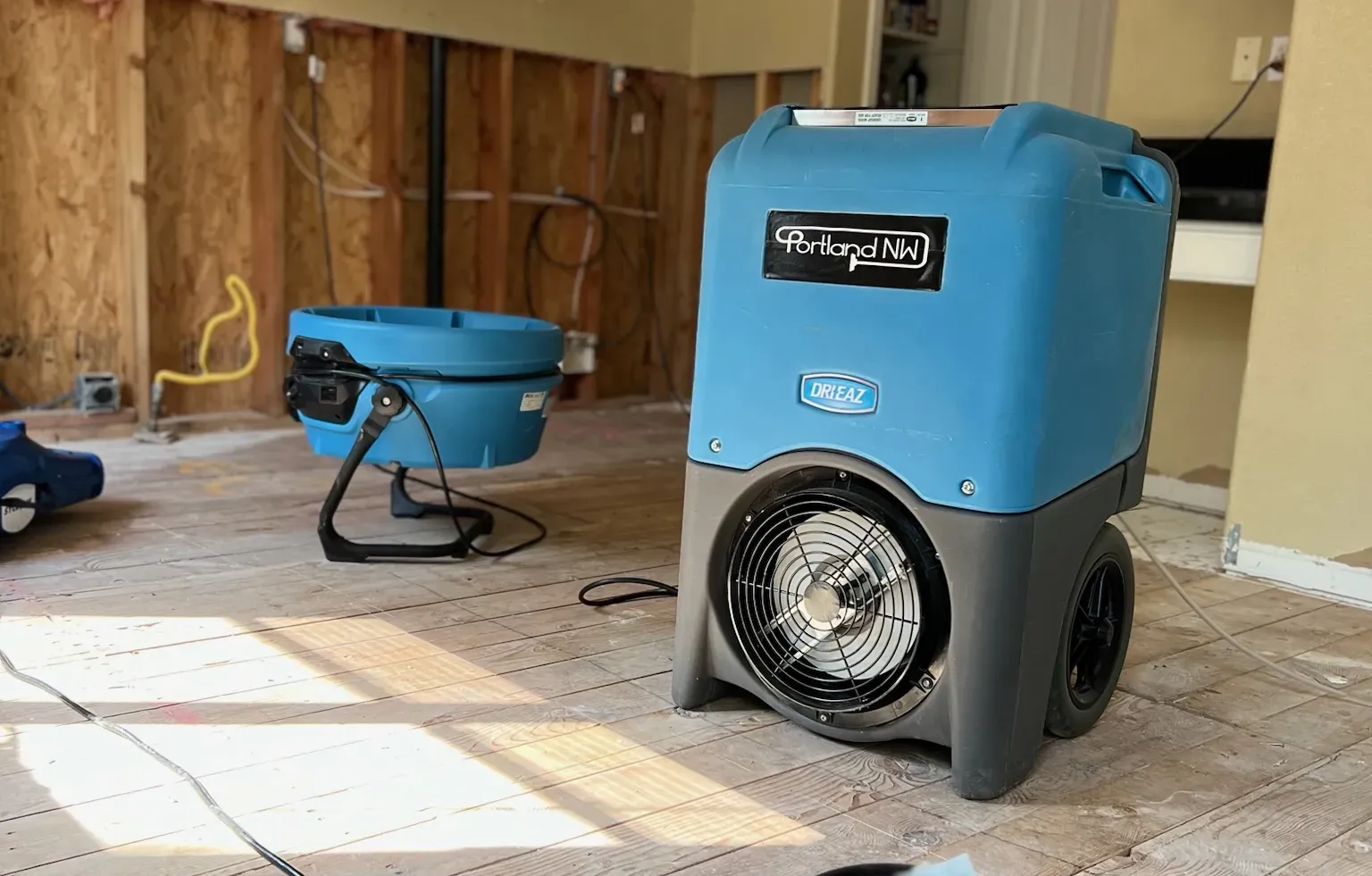 Dehumidifier and air movers in a restoration work area